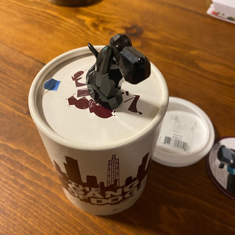 Black Dog Figurine on White Container